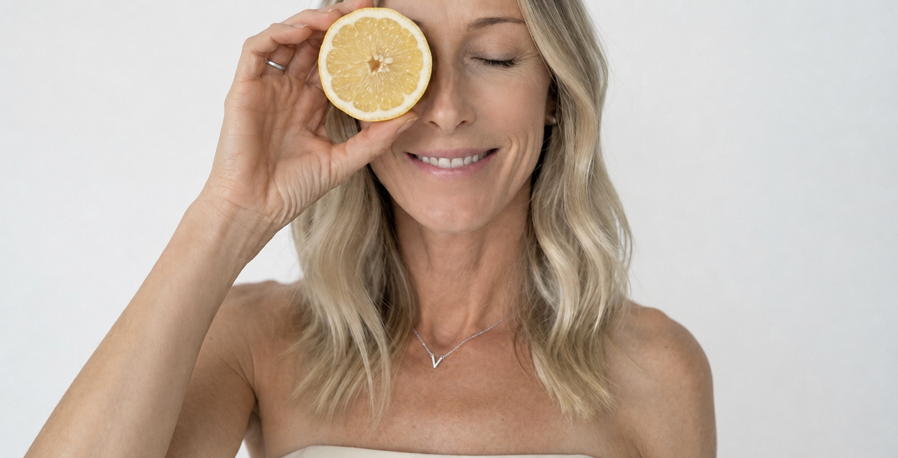 Vicki holding a lemon half, smiling